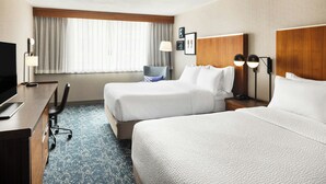 A hotel room with two beds, a desk, a chair, a TV, and a window with curtains. - Four Points by Sheraton Halifax (Halifax)