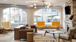A spacious lobby with modern furniture, large windows, and a fireplace. - Four Points by Sheraton Halifax (Halifax)