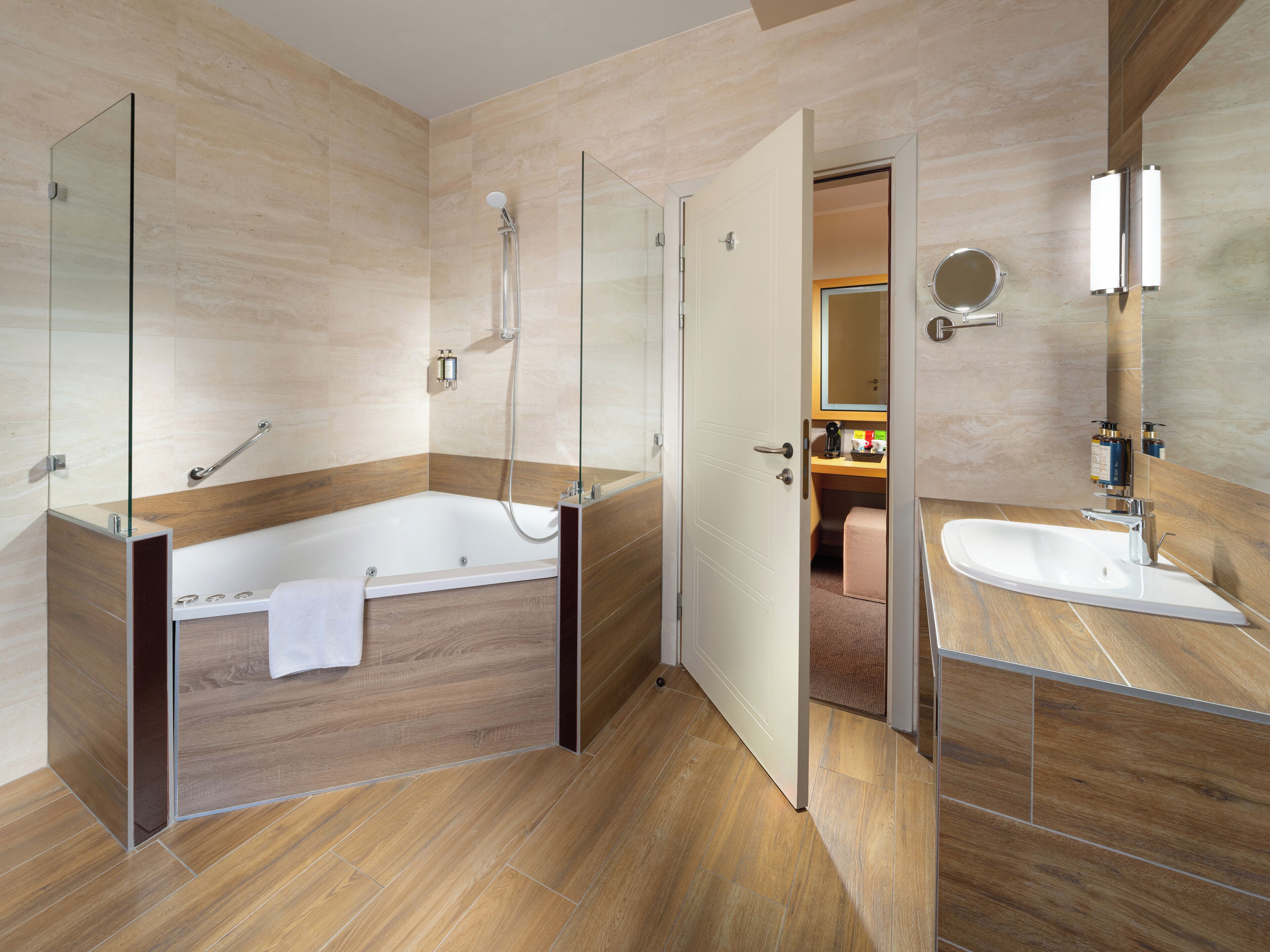 A modern bathroom with a glass-enclosed shower, a freestanding bathtub, and a vanity with a mirror.