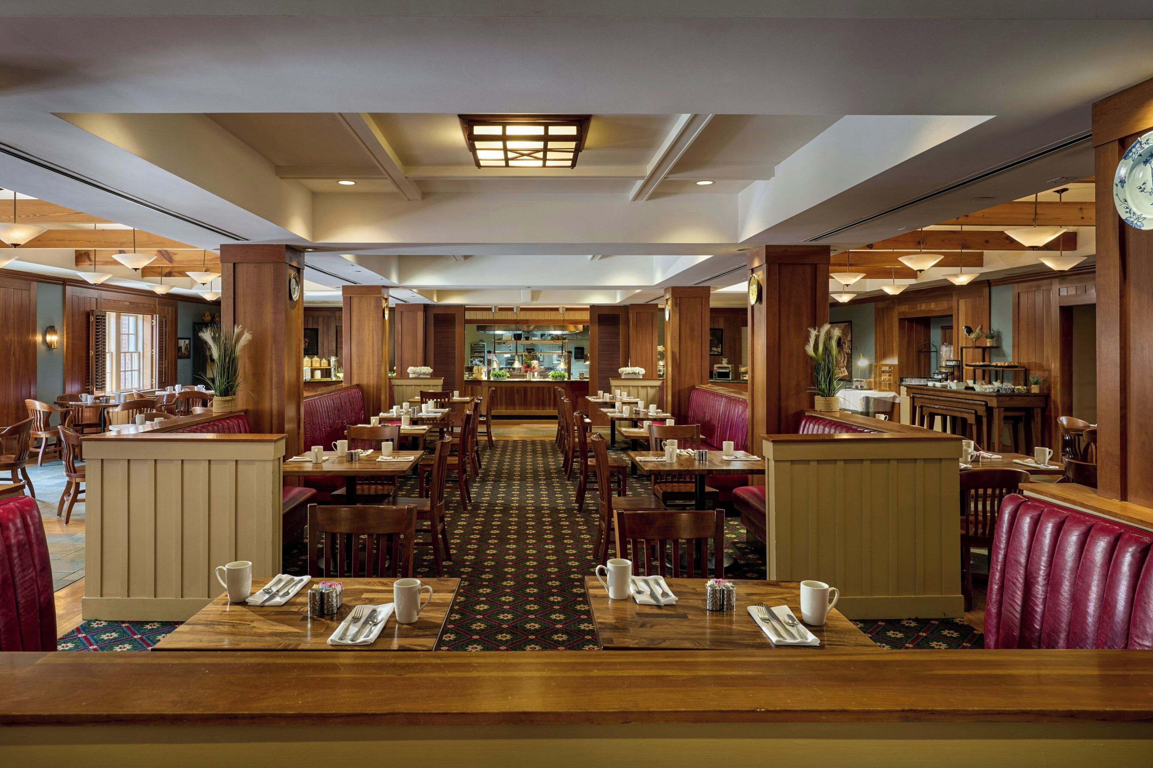 A restaurant with booths, tables, and a central bar area.