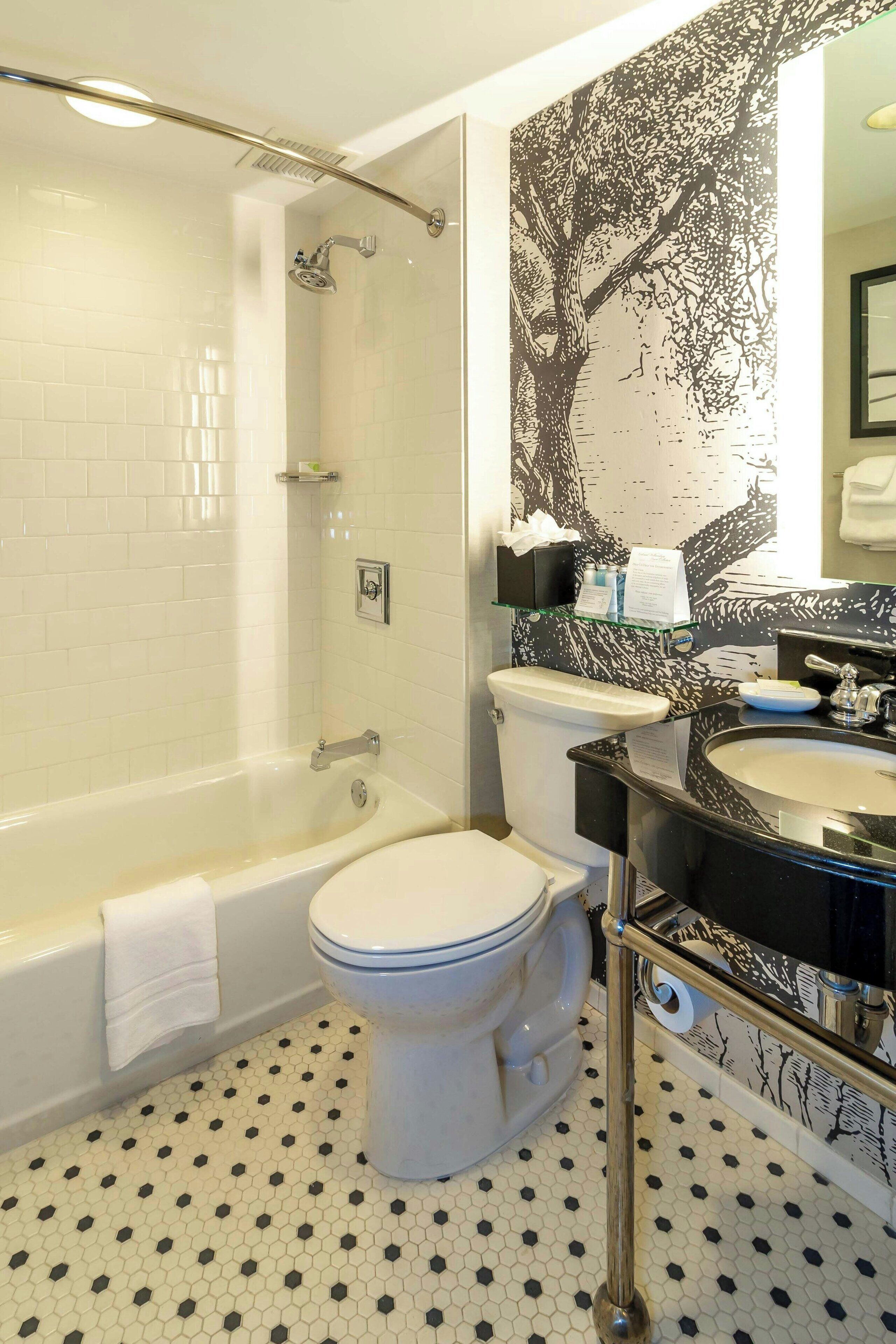 A bathroom with a bathtub, toilet, and sink.