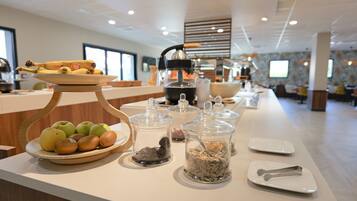 A buffet setup with various food items and condiments.