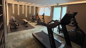 A gym with treadmills, stationary bikes, and weight machines.