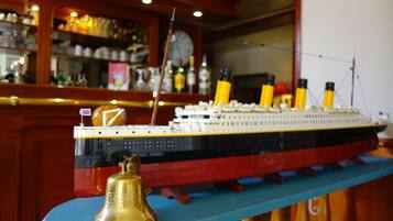 A model of the Titanic on display in a bar setting.