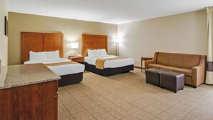 A hotel room with two beds, a sofa, a desk, and a lamp. - Comfort Inn Henderson - Evansville South (Henderson)
