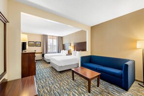 A hotel room with two beds, a blue sofa, a small table, and a carpeted floor. - Comfort Inn & Suites Branson Meadows (Branson)
