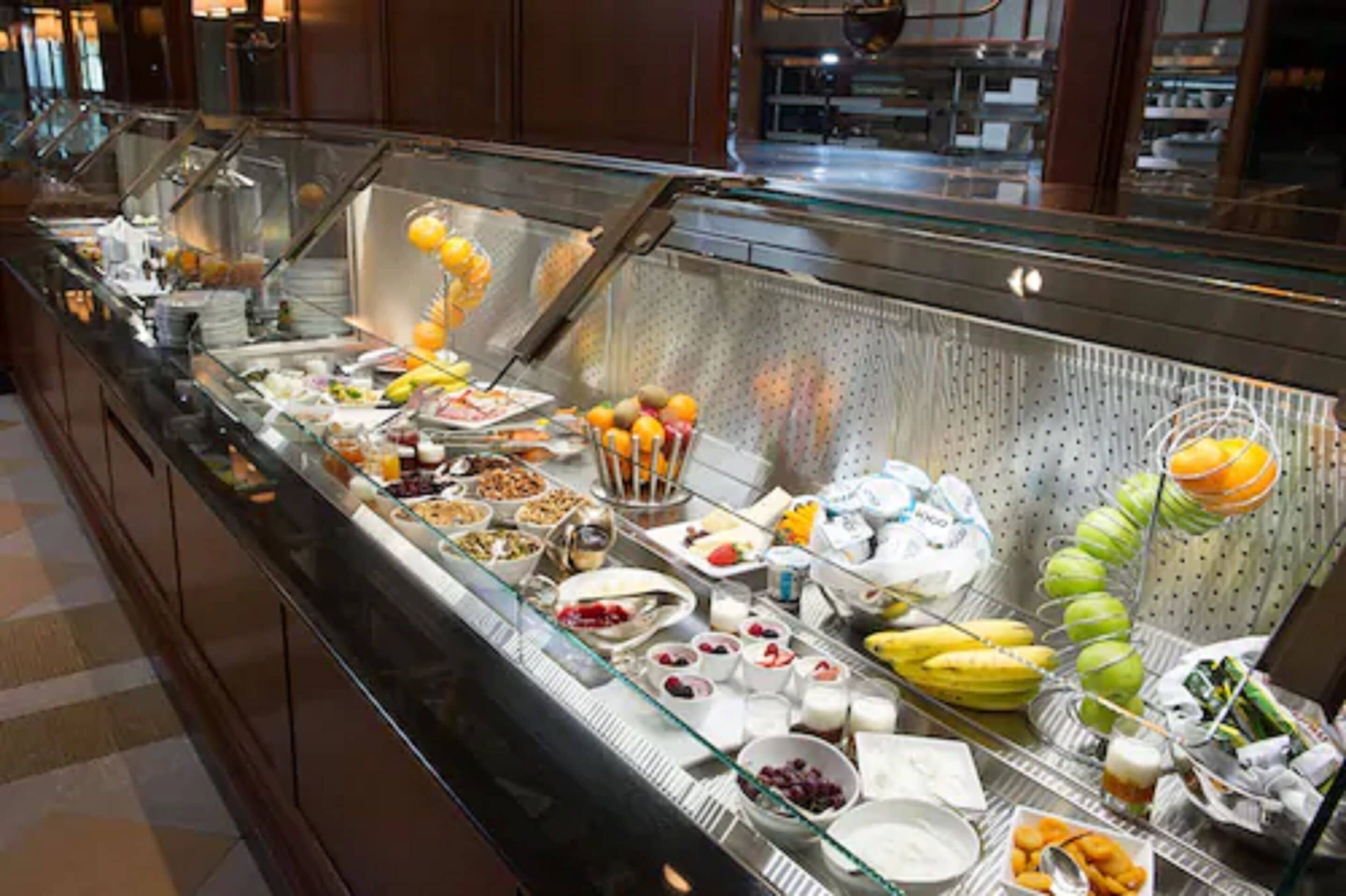 A buffet with various food items and beverages.