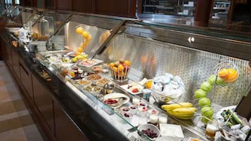 A buffet with various food items and beverages.