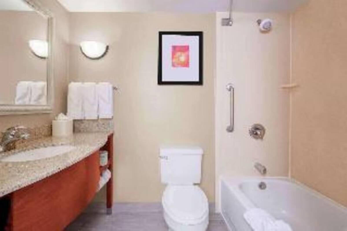 A bathroom with a sink, toilet, and bathtub.