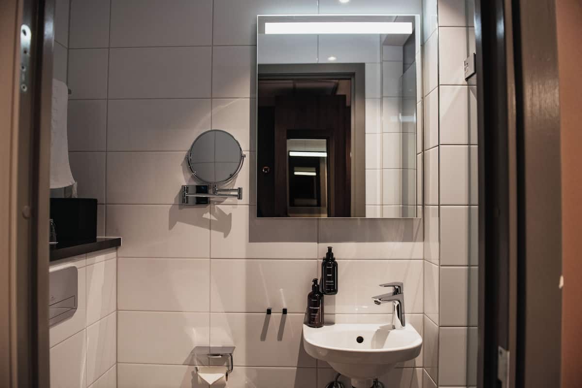 compact single | bathroom | shower, hair dryer, towels