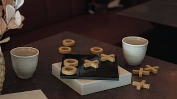A table with a book, a cup, and wooden shapes.