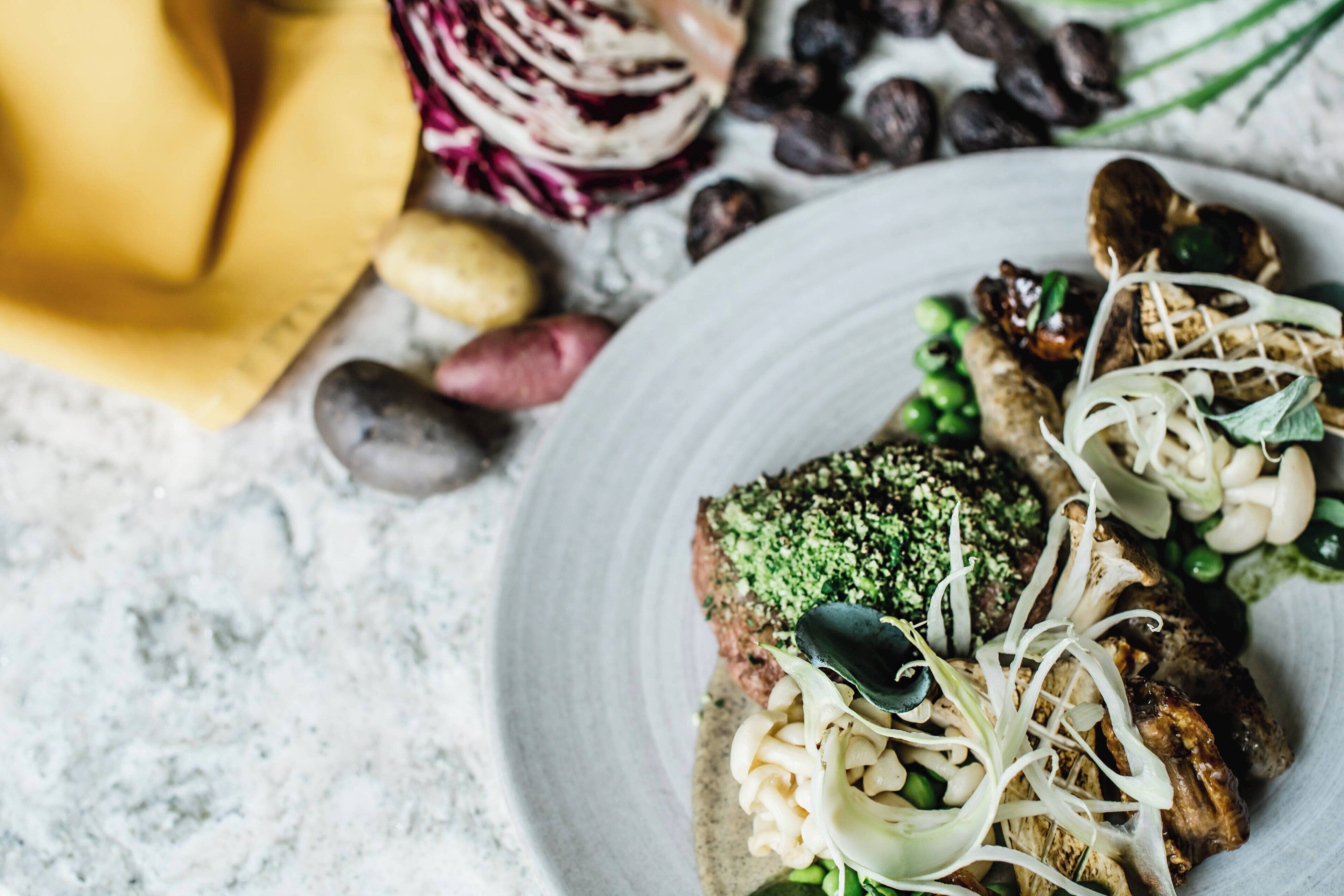 A plate of food with mushrooms, peas, and sprouts.