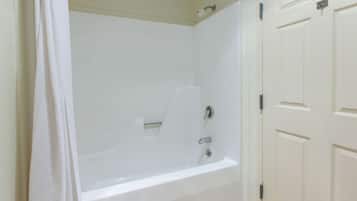 A bathroom with a bathtub, a shower, and a toilet.