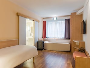 Hypo-allergenic bedding, desk, laptop workspace, blackout drapes