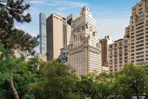 A cityscape with tall buildings, including a mix of modern and classical architecture.