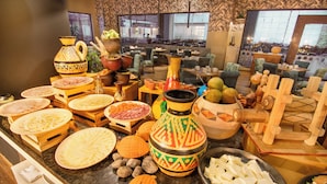 A buffet with various dishes and decorative pottery.