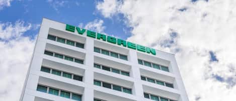 A multi-story building with the name 'EVERGREEN' prominently displayed on the facade.