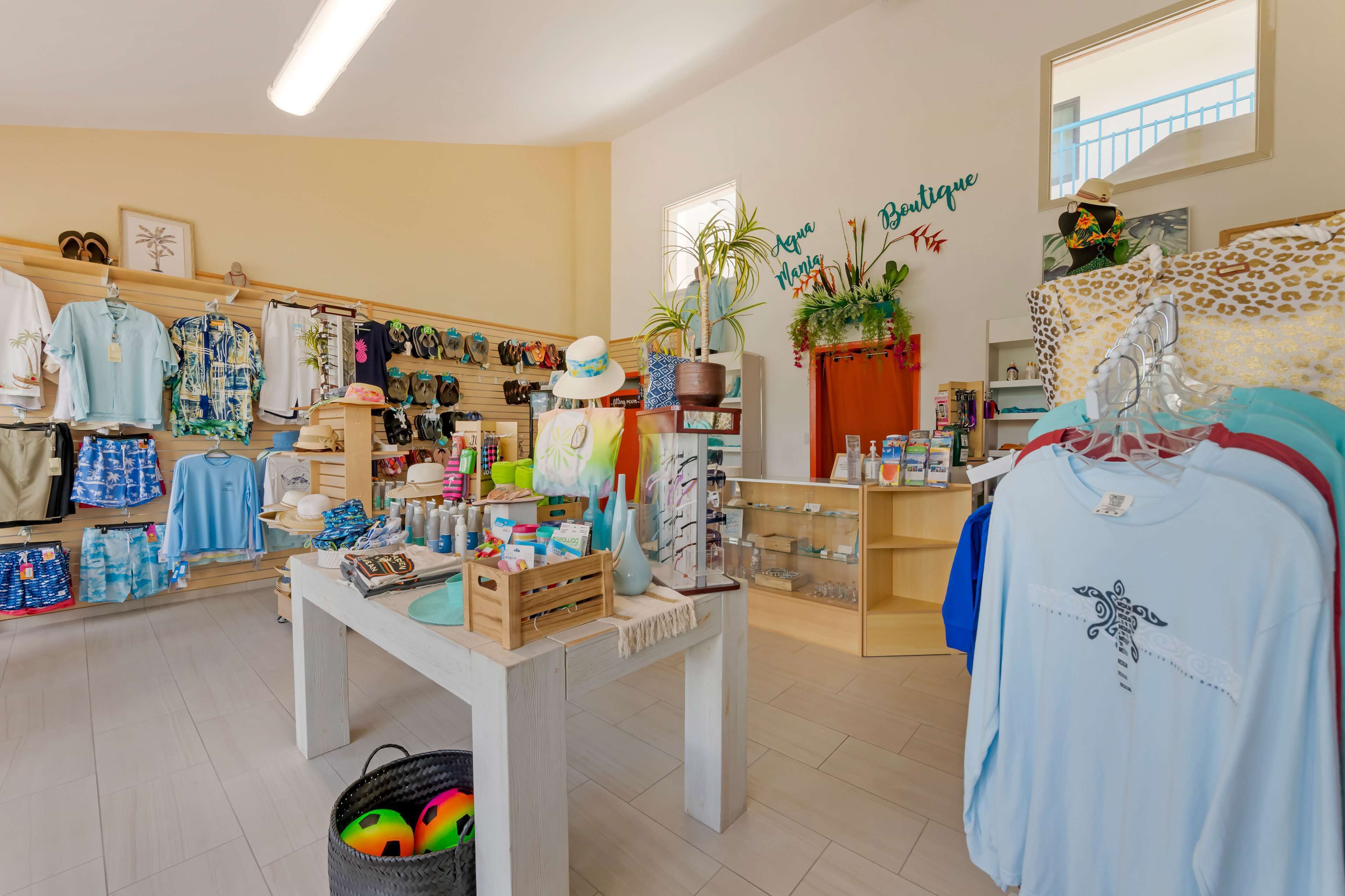 A boutique store with various clothing items, a table with accessories, and a wall with a 'Boutique' sign.
