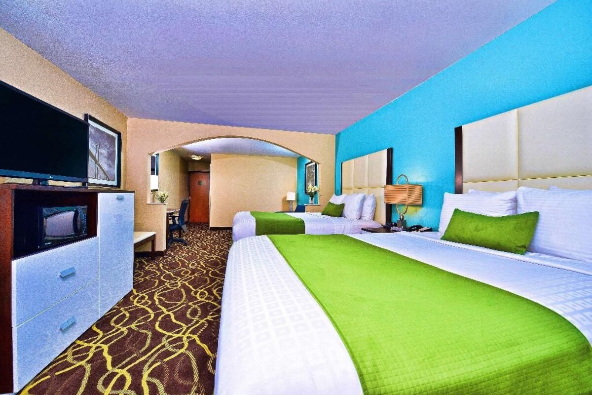 Premium bedding, desk, laptop workspace, blackout drapes