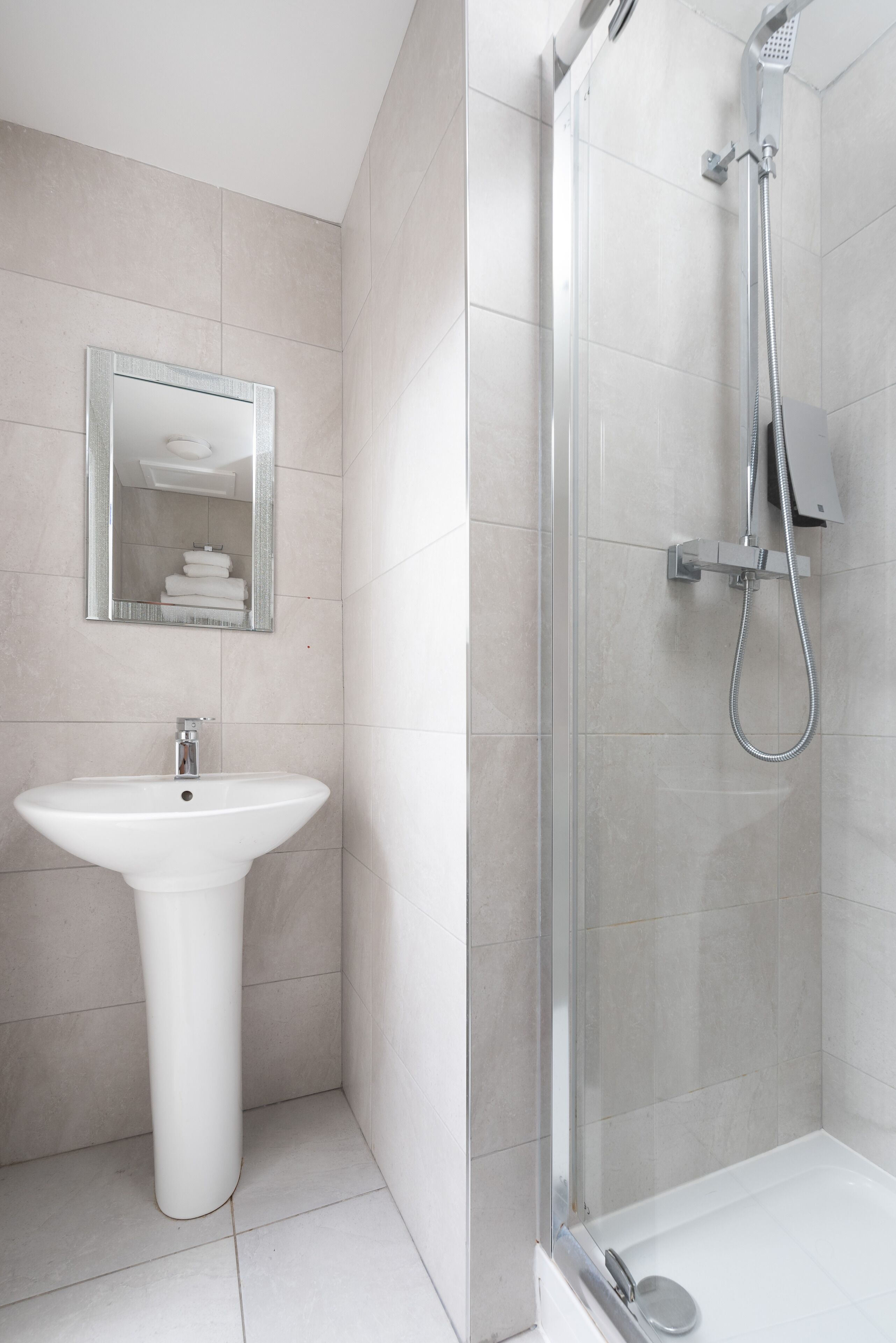 Shower, designer toiletries, hair dryer, towels