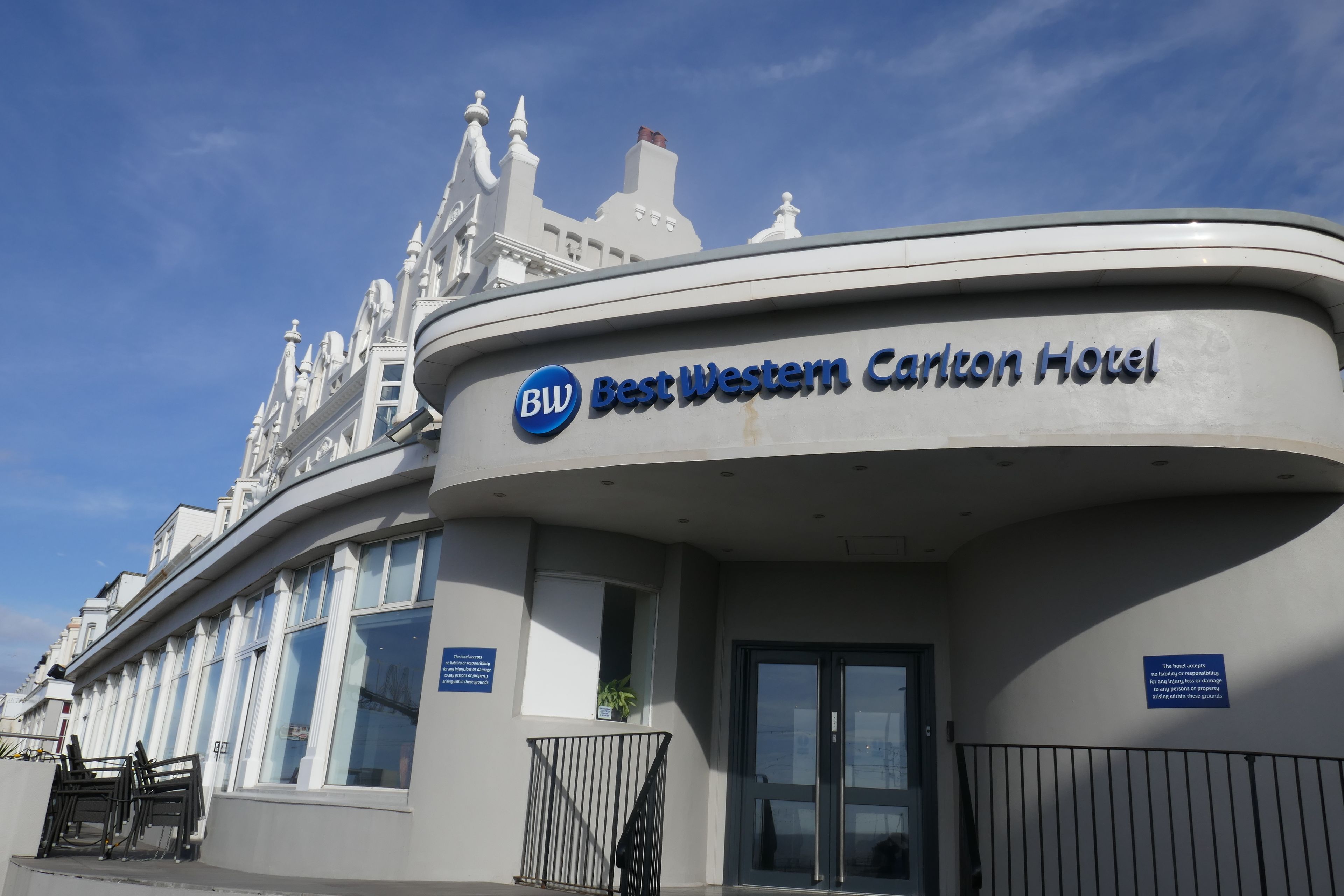 The exterior of the Best Western Carlton Hotel with a clear blue sky in the background.