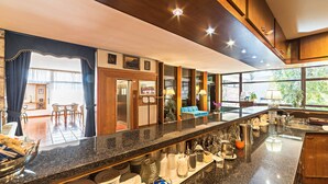 A modern kitchen with granite countertops, stainless steel appliances, and a view of the dining area. - Garden Hotel (Terni)