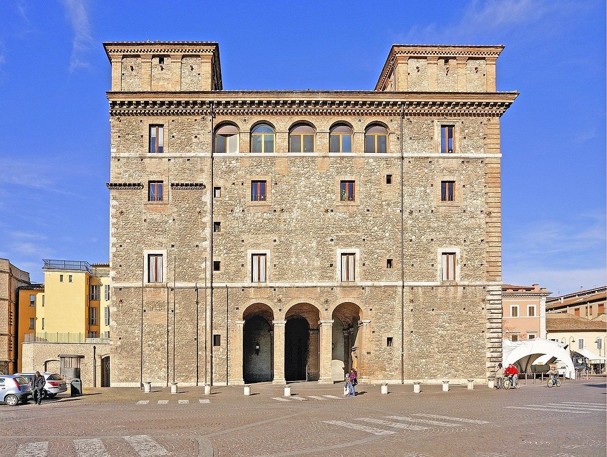 A historic stone building with multiple arches and a central entrance.