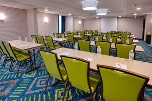 A conference room with multiple tables and chairs, water bottles on tables, and a patterned carpet. - Drury Inn & Suites Nashville Airport (Nashville)