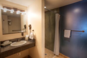 A bathroom with a sink, mirror, and towel rack.