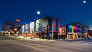 A hotel with a large mural on the facade, a prominent 'Ruby' sign, and a street view with cars and buildings. - Hotel Ruby (Spokane)