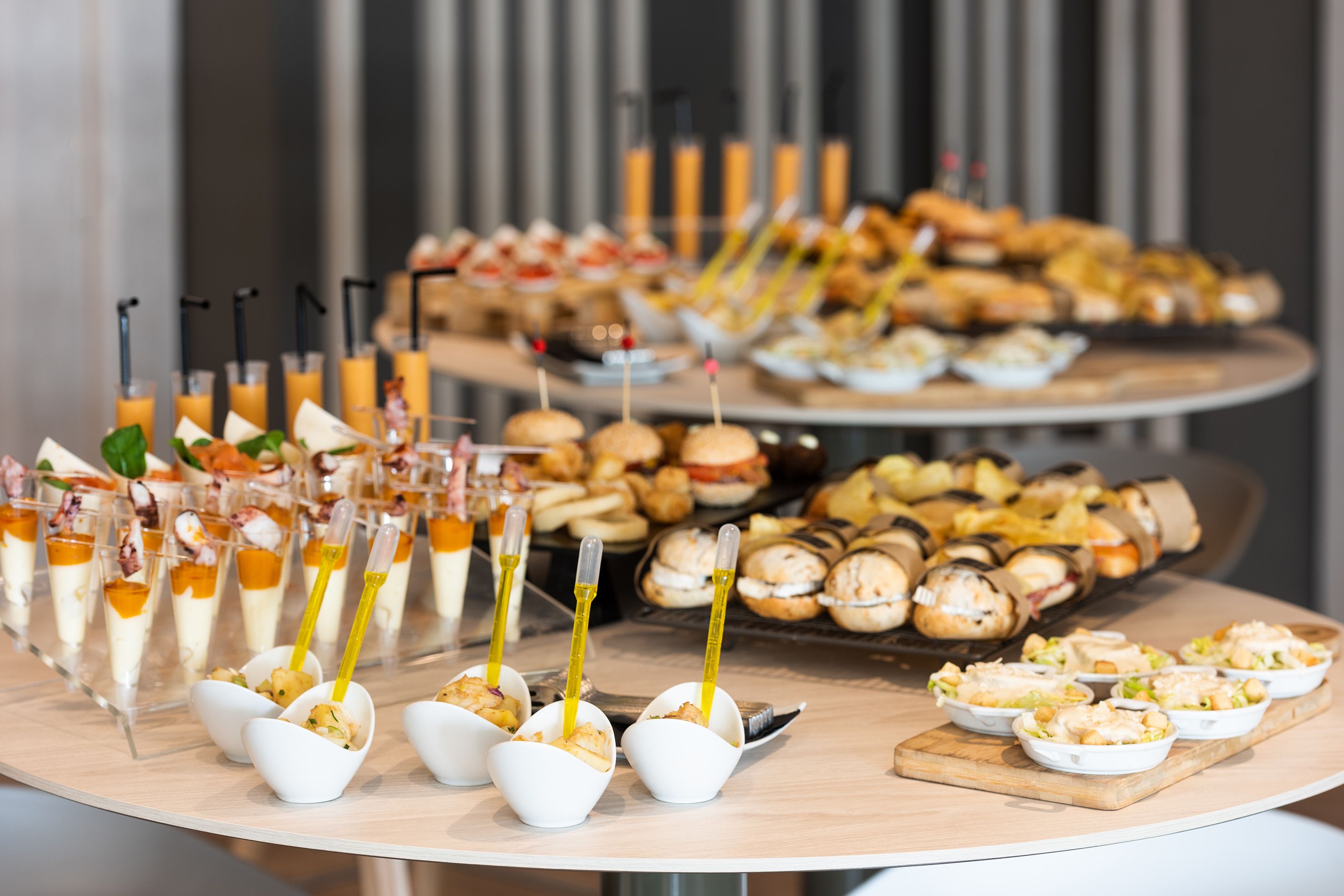 A buffet table with various food items and drinks.