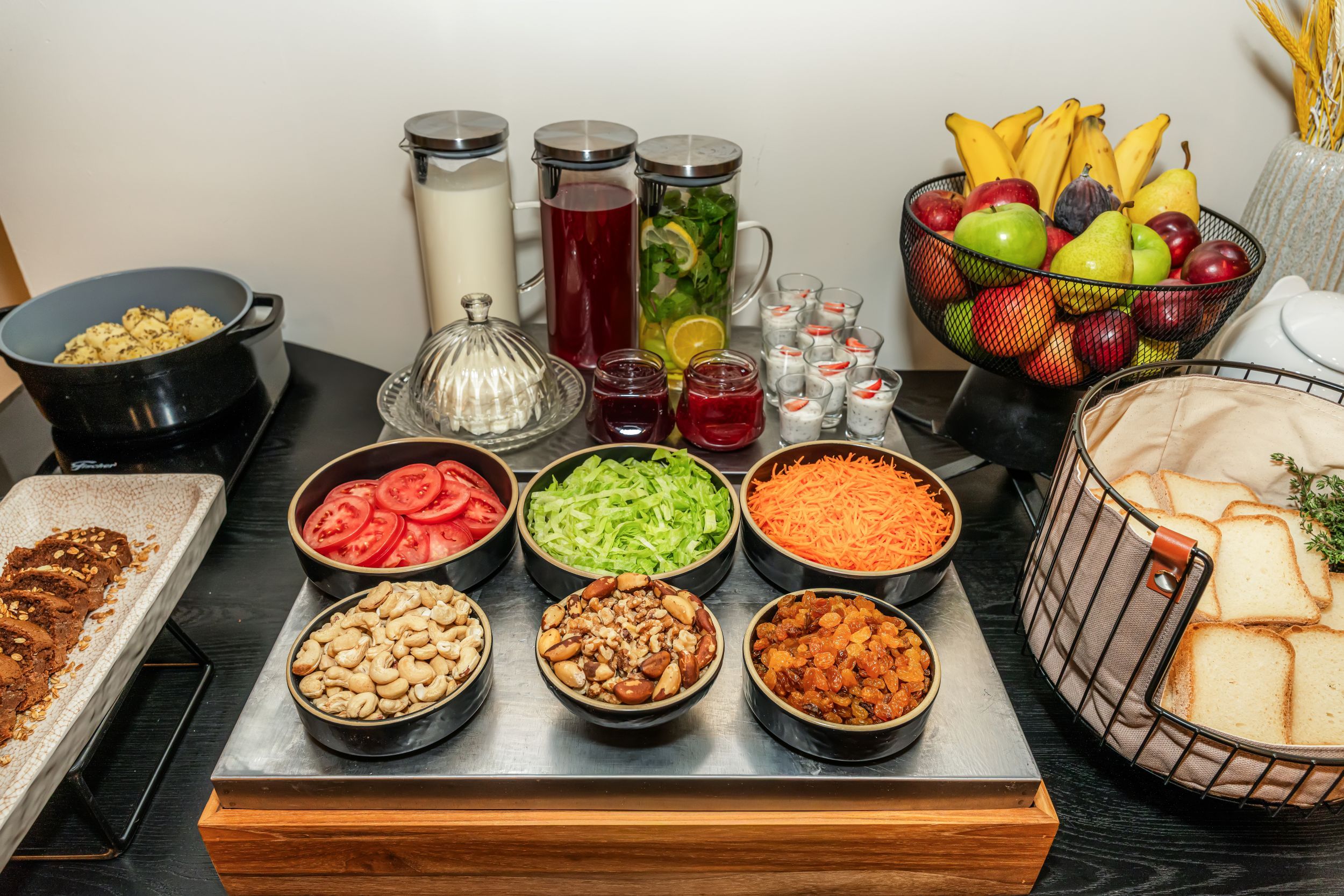 A buffet table with various food items and beverages.