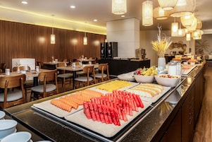 A buffet setup with various fruits and vegetables.