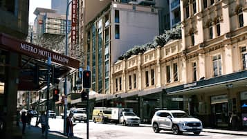 A street view with the Metro Hotel Marlow sign, a Chamberlain store, and a white SUV parked on the side.