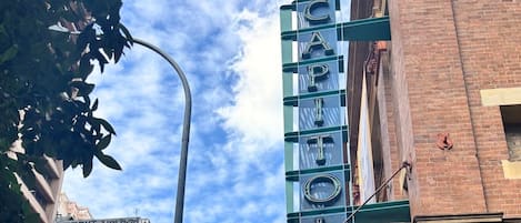 A building with a marquee sign reading 'CASIO' and a street lamp in the foreground.