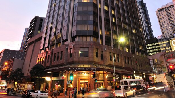 A modern hotel with a prominent corner entrance, multiple floors, and a large glass facade. - Metro Hotel Marlow Sydney Central (Haymarket)
