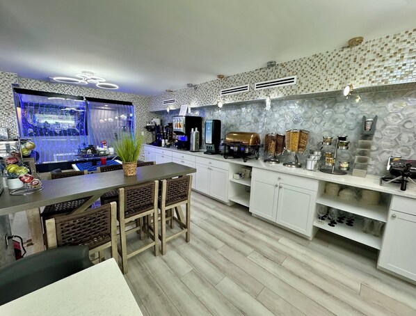A modern kitchen with a central island, white cabinetry, and a decorative backsplash.