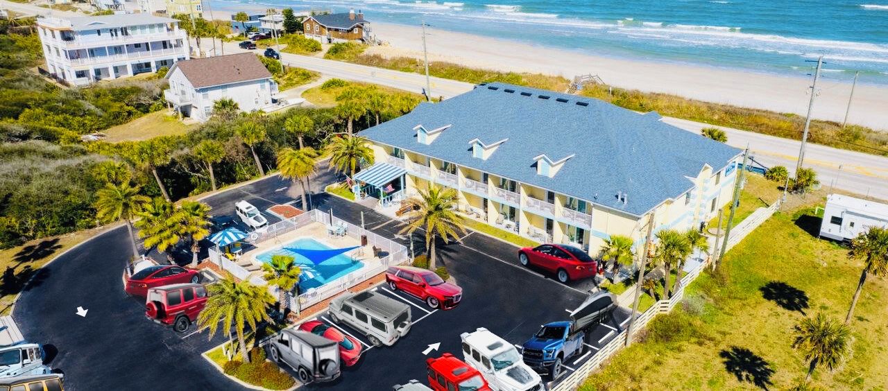A 1-acre private beach with a building, parking, and a pool.