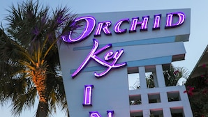 A neon sign for Orchid Key Inn with a 'VACANCY' sign below it. - Orchid Key Inn - Adults Only (Key West)