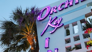 A building with a neon sign that reads "Orchid Key Inn." - Orchid Key Inn - Adults Only (Key West)