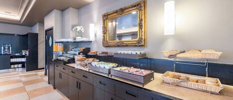 A buffet area with various food options, a mirror, and a wall-mounted light fixture.