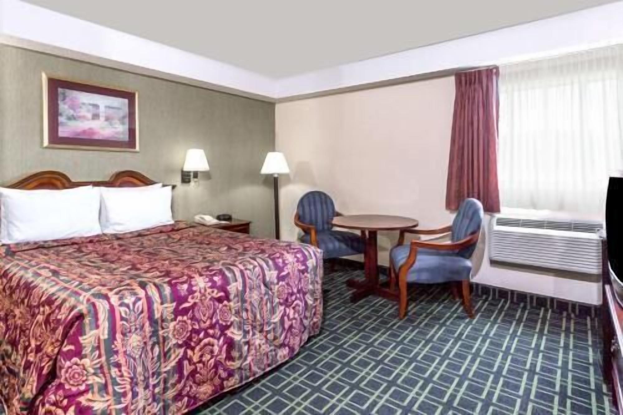 Hypo-allergenic bedding, desk, laptop workspace, blackout drapes