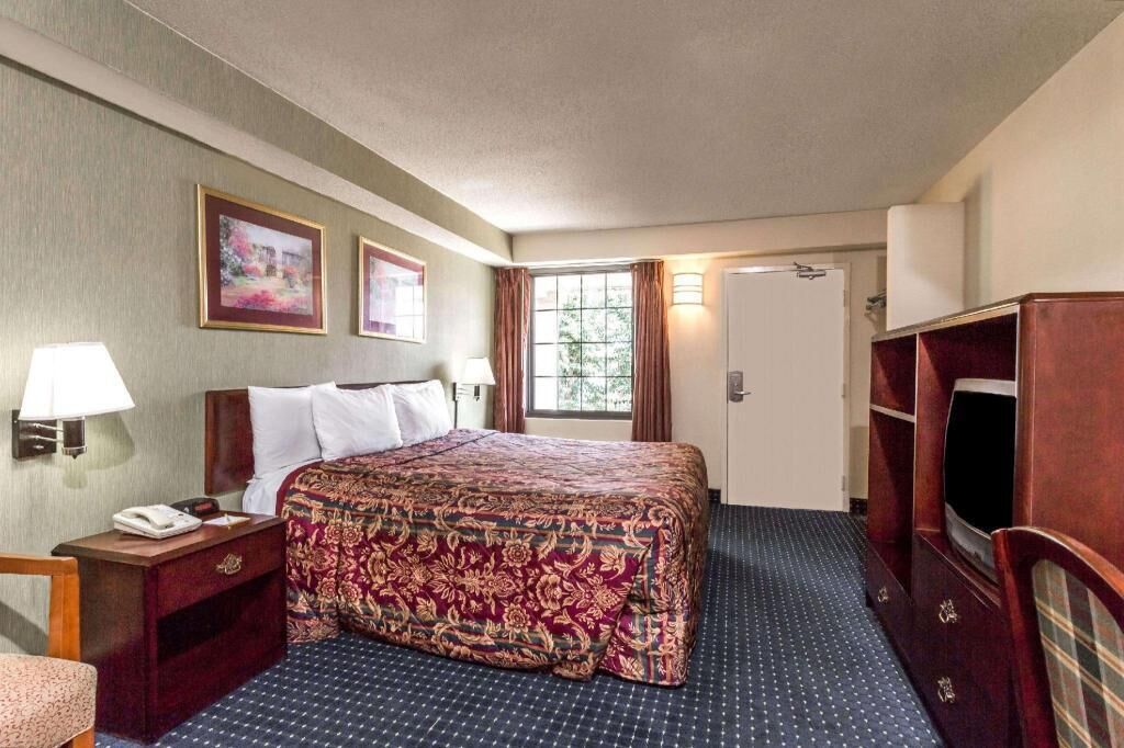 Hypo-allergenic bedding, desk, laptop workspace, blackout drapes