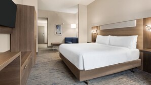 A hotel room with a large bed, a TV, a desk, and a chair. - Holiday Inn Express & Suites Greenville - Downtown by IHG (Greenville)