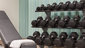 A gym with a bench and multiple rows of dumbbells. - Holiday Inn Express & Suites Greenville - Downtown by IHG (Greenville)
