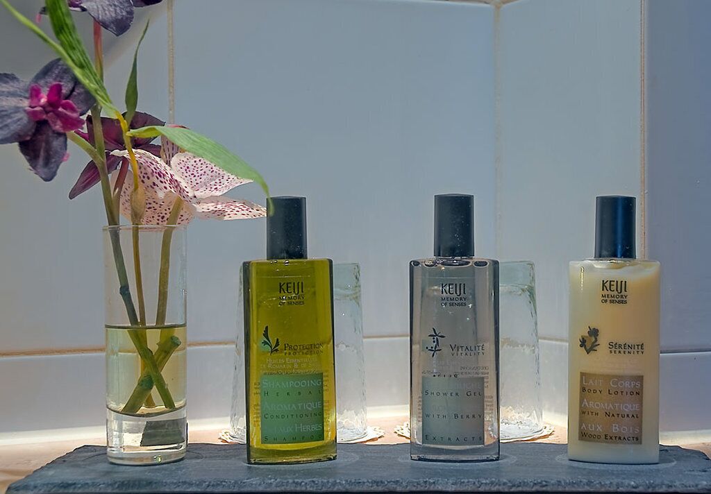 designer toiletries, hair dryer, bathrobes, slippers