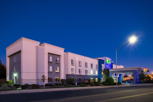 Hotel with a two-story structure and flat roof, featuring a symmetrical facade with evenly spaced windows.