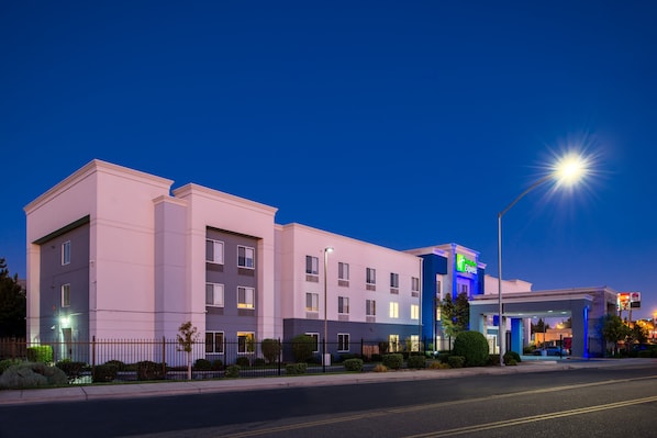Hotel with a two-story structure and flat roof, featuring a symmetrical facade with evenly spaced windows.