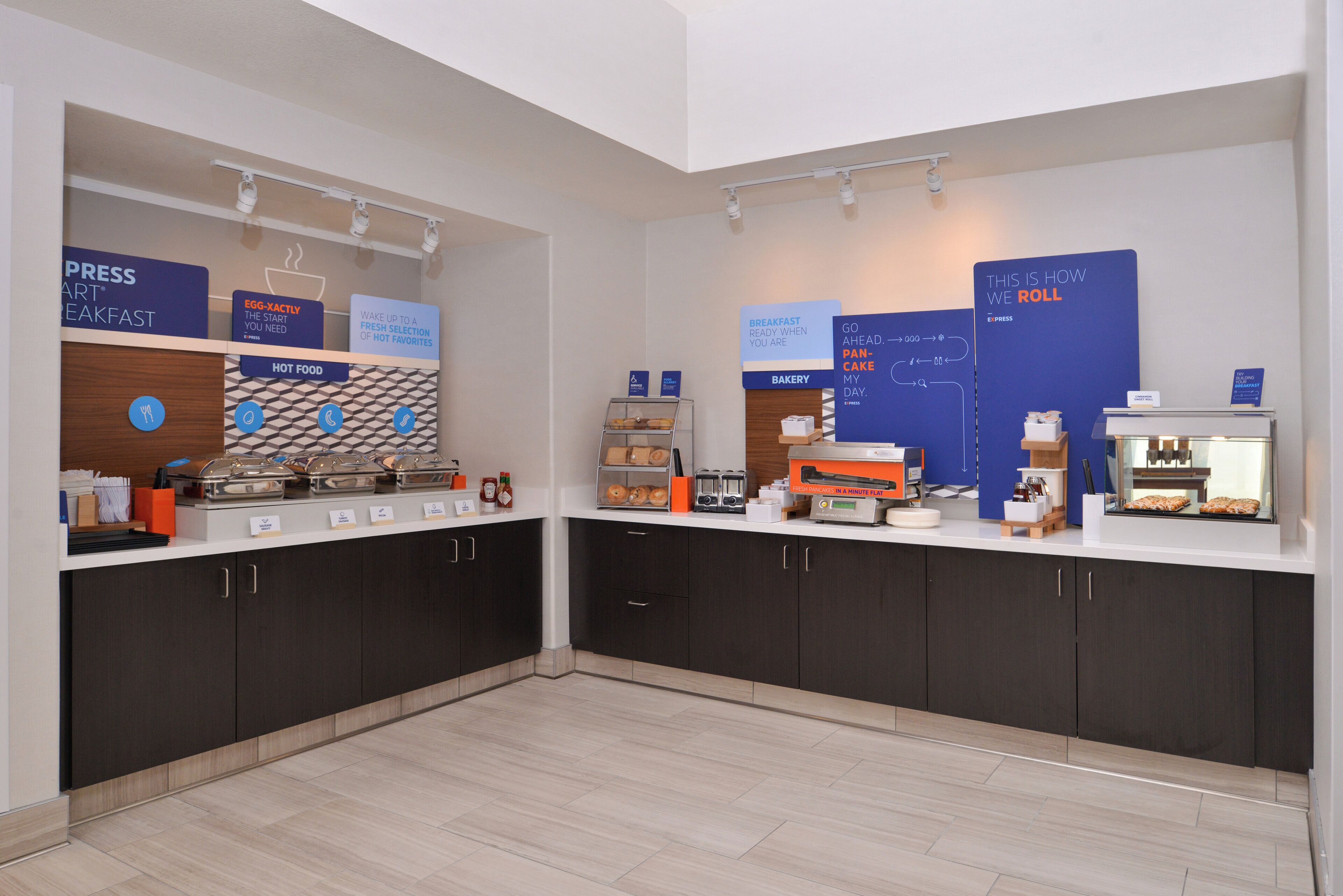 A breakfast area with labeled sections for hot food, bakery, and express breakfast.