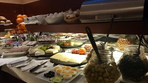 A buffet with various food items including cheese, fruits, and olives. - AltDüsseldorf (Düsseldorf)